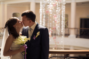 bride and groom in banquet hall kissing
