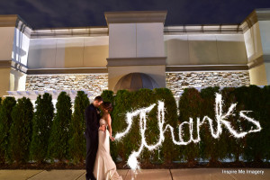 bride and groom write thanks with sparklers