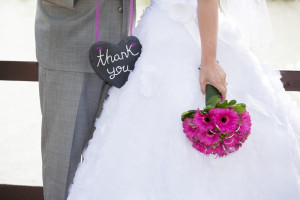bride and groom with thank you sign