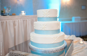 white wedding cake with blue ribbon