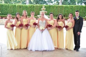 bridesmaids in yellow with red calla bouquets
